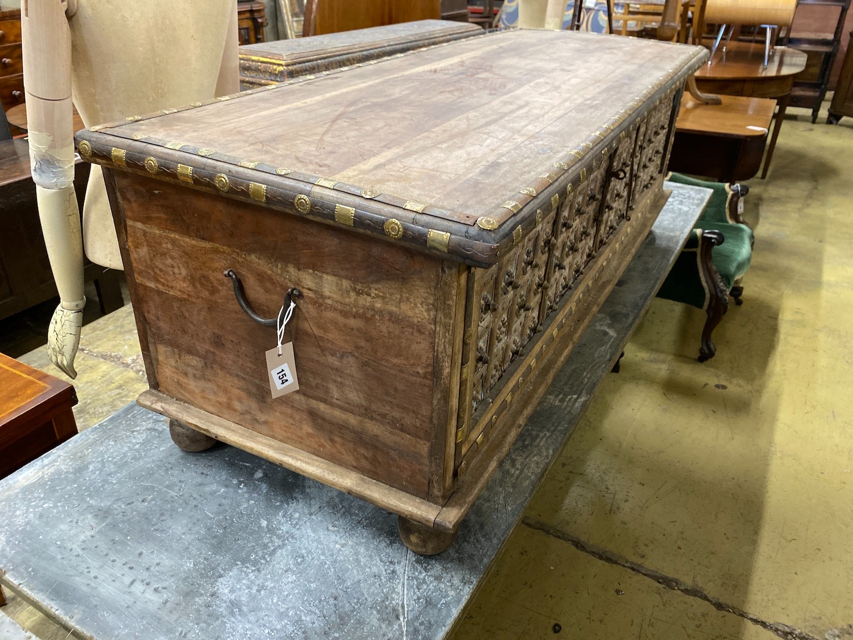 A South Asian brass mounted carved hardwood coffer, length 145cm, depth 55cm, height 50cm